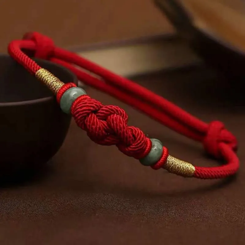 Hand-knotted red string bracelet with a traditional knot